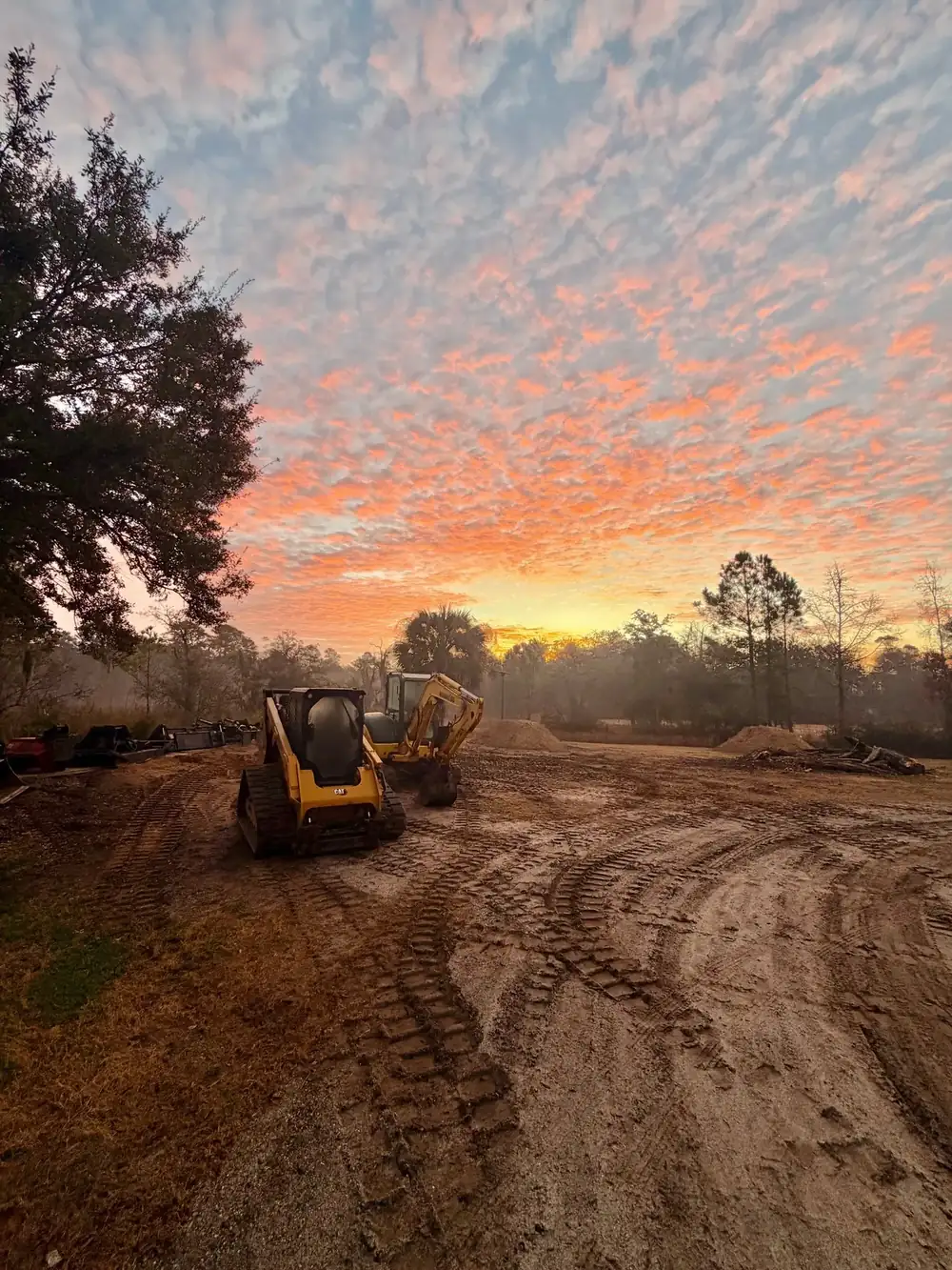 Graded lot at sundown with a track loader